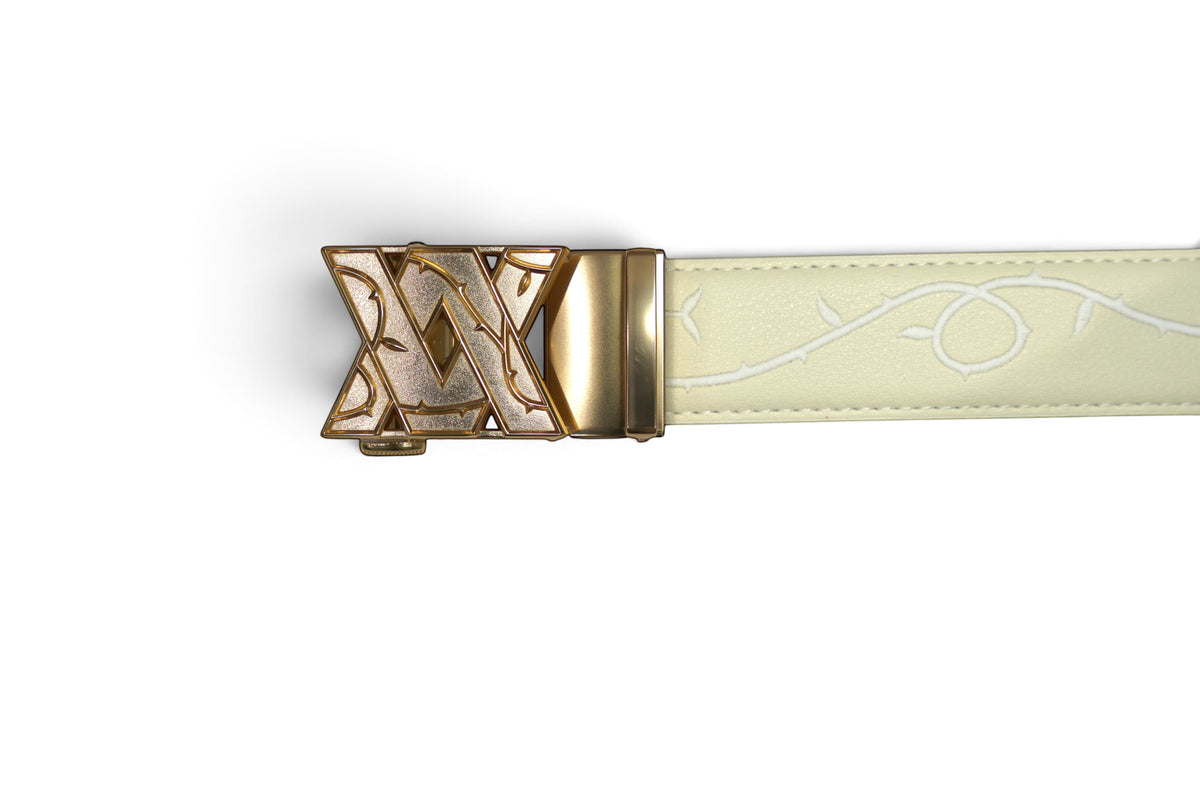 VASANA cream leather belt featuring an intricate embroidered vine pattern and a decorative gold-tone metal buckle