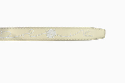 VASANA white premium leather belt featuring a delicate engraved rose vine pattern and subtle brand logo detail.